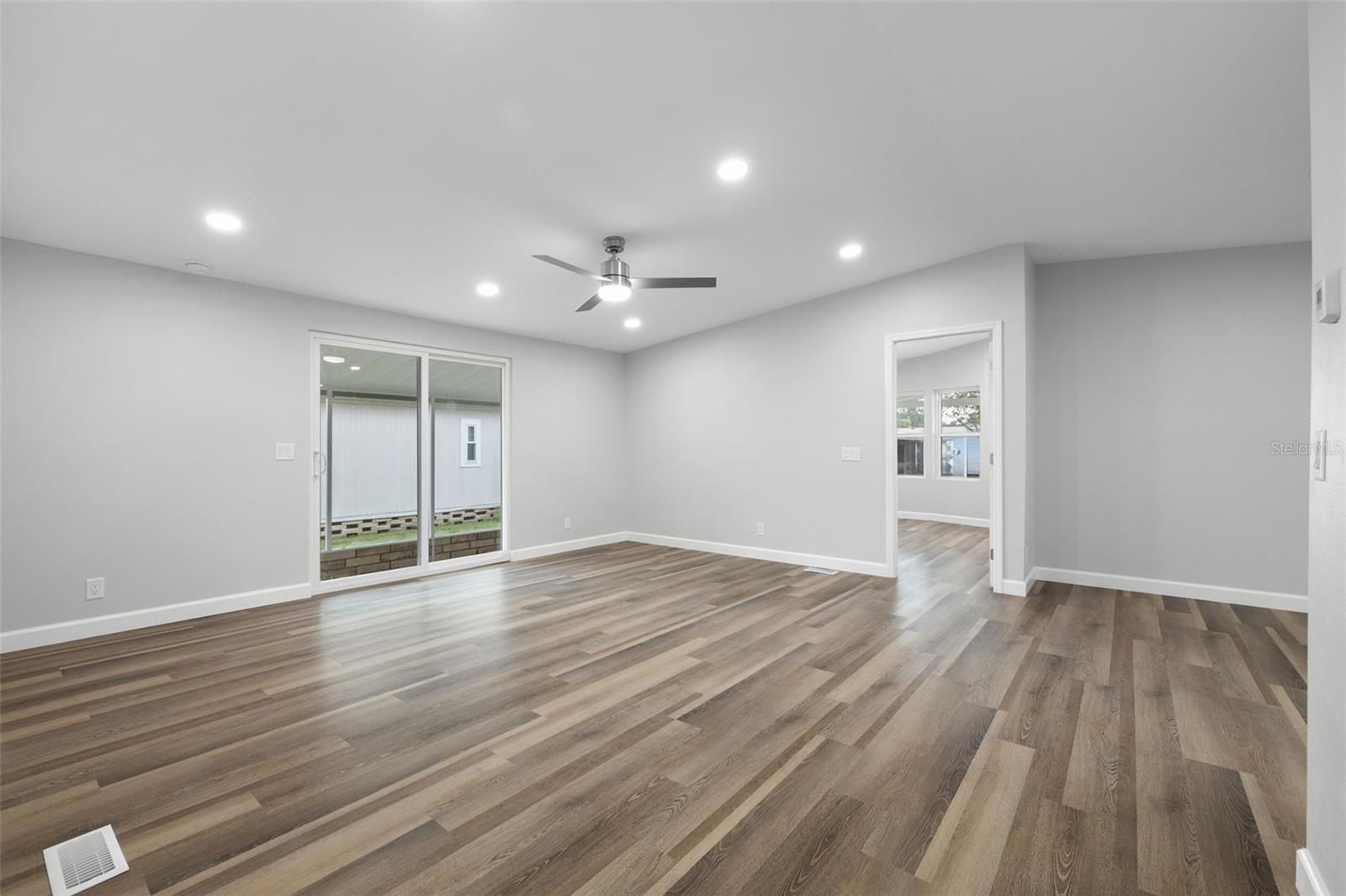 Large, open and versatile room! Extra recessed lighting and brand new ceiling fan in this large room!