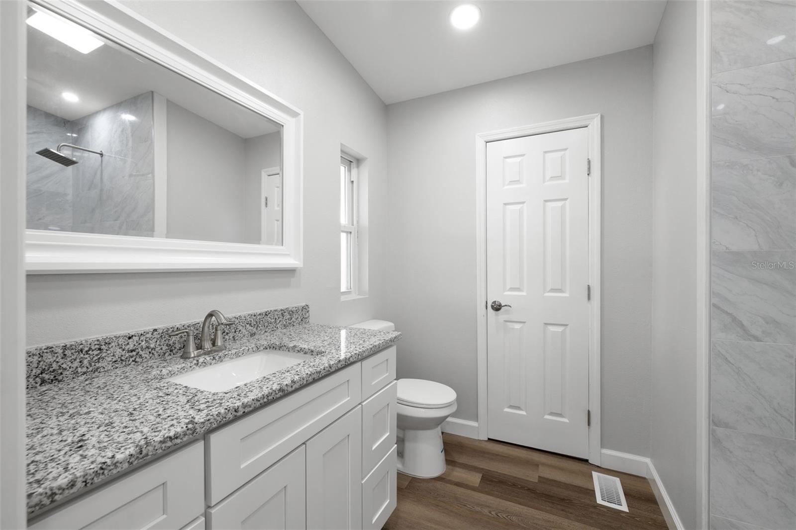 New Everything here!  Comfort height toilet, new door, mirror, vanity with soft close drawers, fixtures....AND an extra feature- HOME SMART bathroom fan with various ambient lighting, and the ability to stream music through your phone!