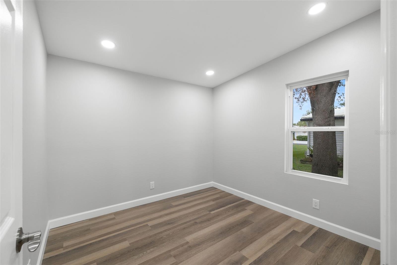 Third bedroom...or office-  FLEX room!  Features recessed lighting, new windows, flooring, and door!