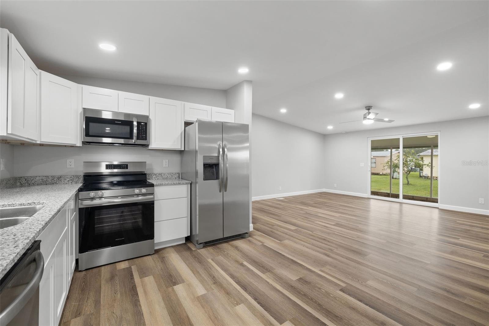 View from kitchen toward the open concept dining room/living room.