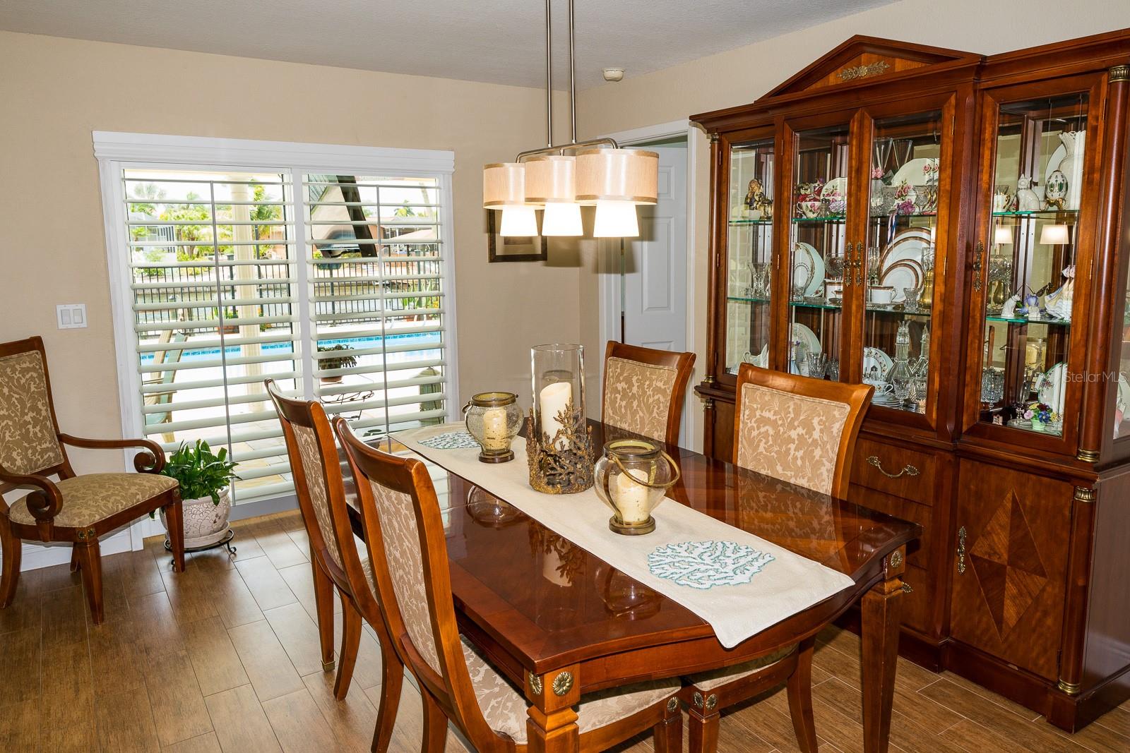 Dining room with slider to back lanai.  Flooring is tile with wood grained look.