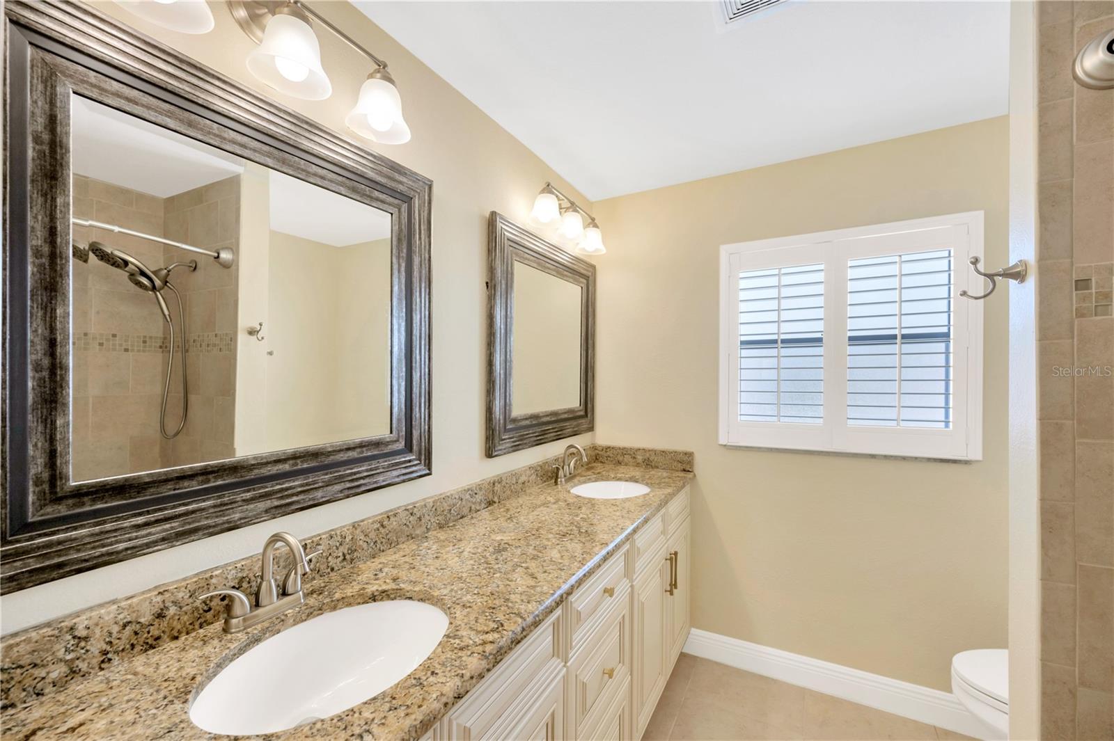 Guest bath between bedrooms 2 & 3 has dual sinks and tub/shower combo.