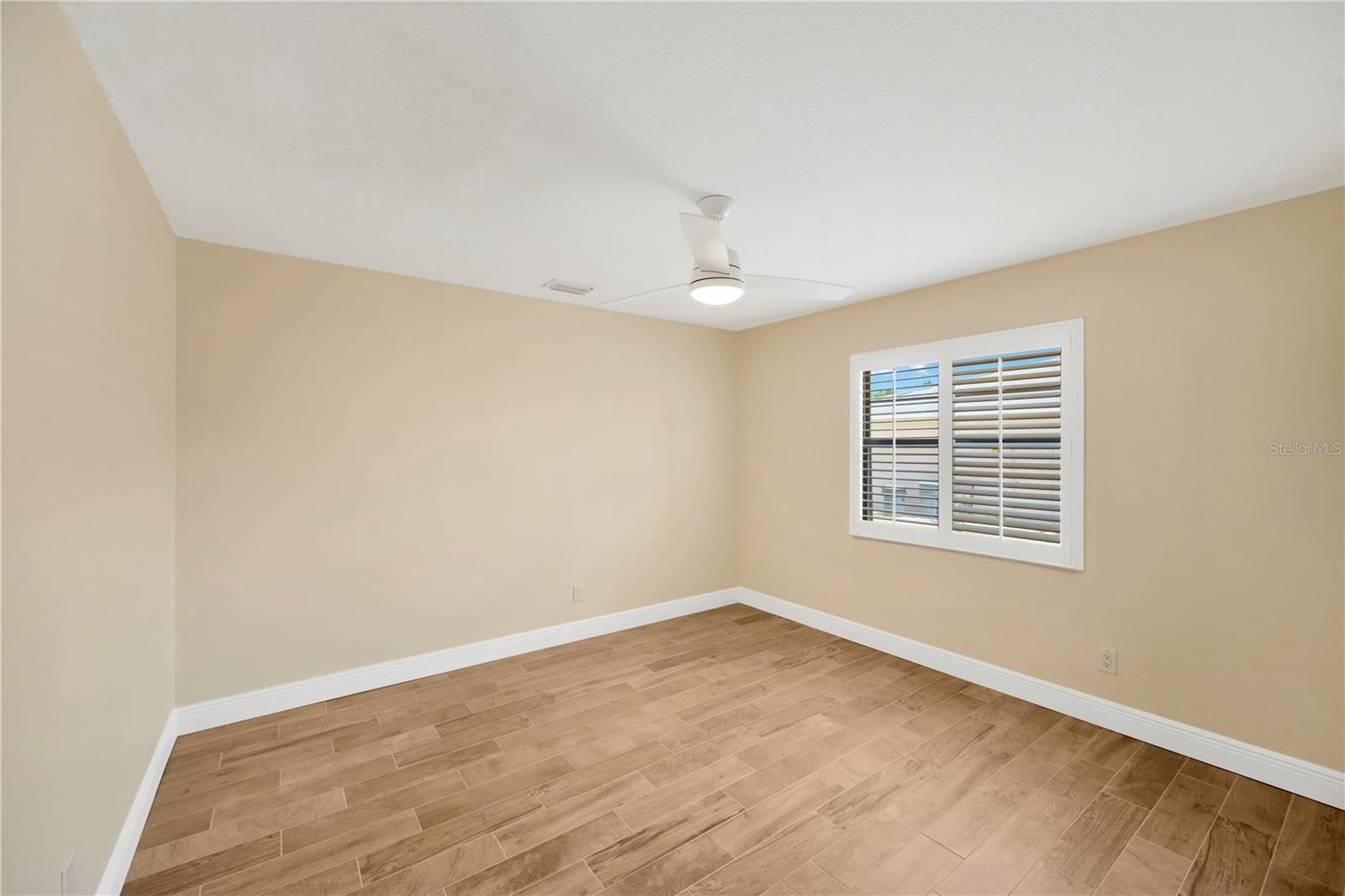 Bedroom # 3 is 11' x 12' with wood grained tile, ceiling fan and built-in closet.