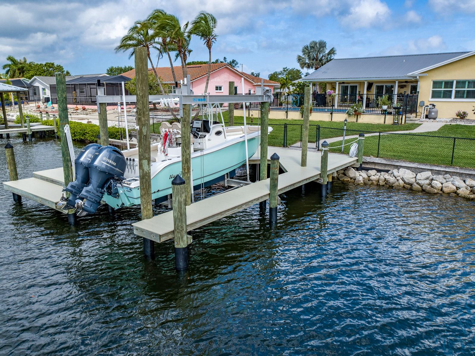 The boat lift has the capacity for a 13,000 lb vessel and operates with a remote control.