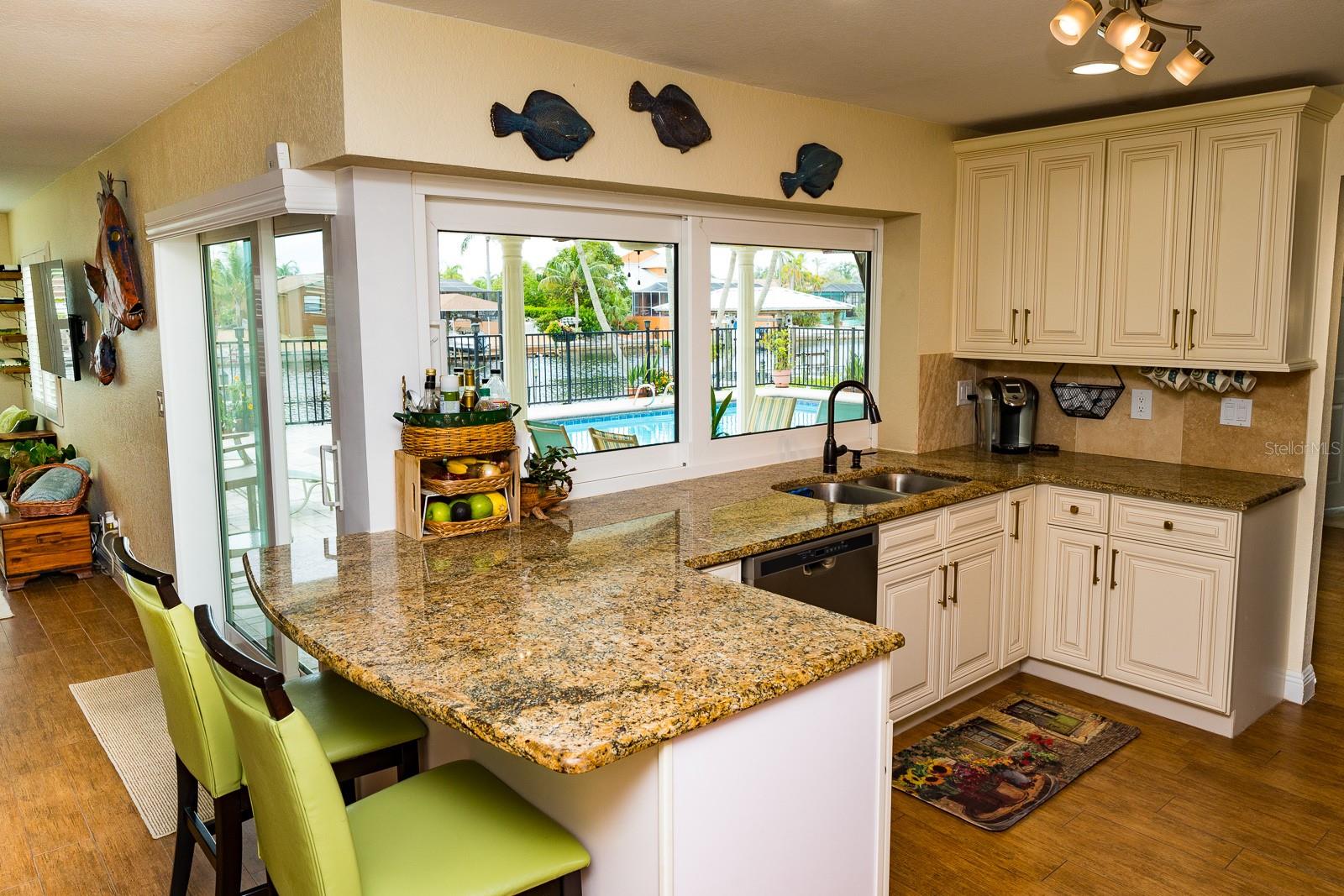 Kitchen with sliding window pass through counter for entertaining inside and outside by the pool