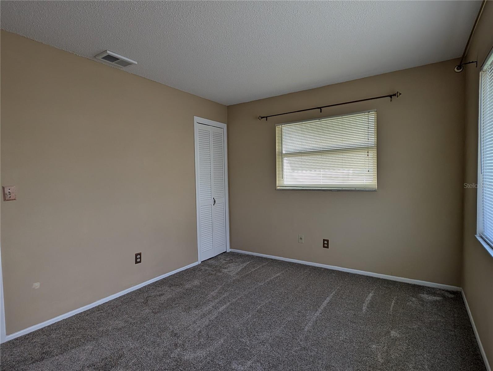 Guest bedroom offers new carpeting, two windows for great lighting and a closet.