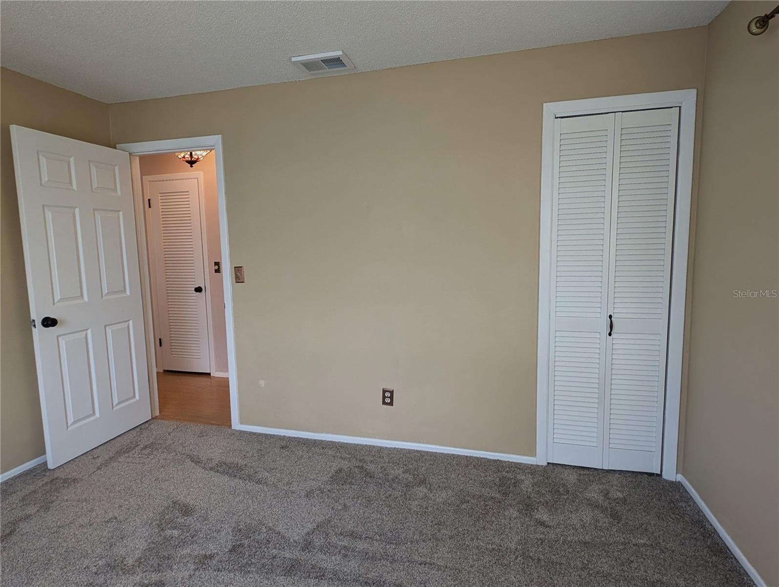 View from guest bedroom to hallway.  Primary bedroom is directly across from guest bedroom.