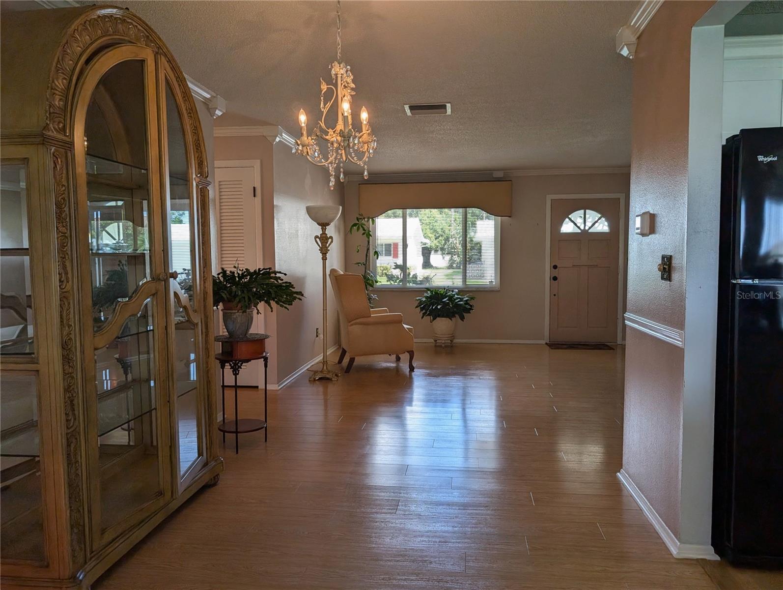 View from Florida room thru dining and living room to front entry.  Kitchen to right.  Hallway on left.