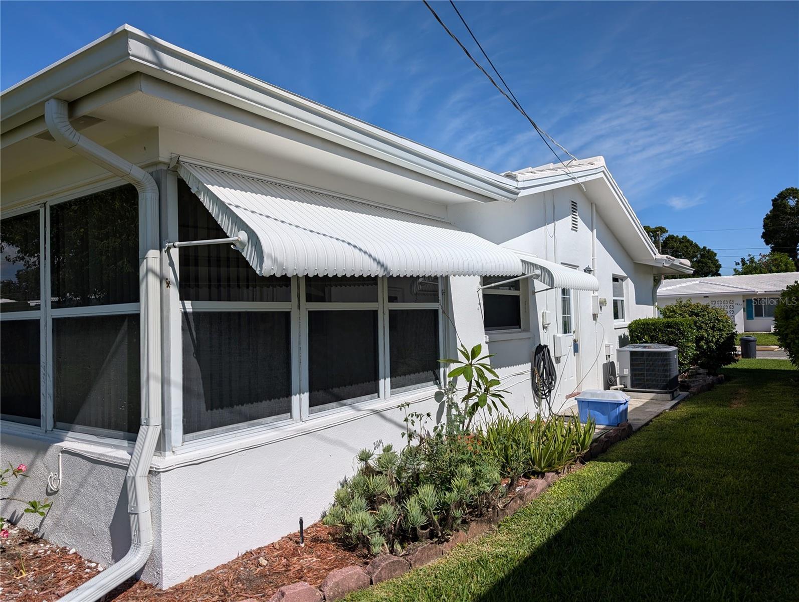 Exterior side view of home.  Garage entry door accessess side yard.