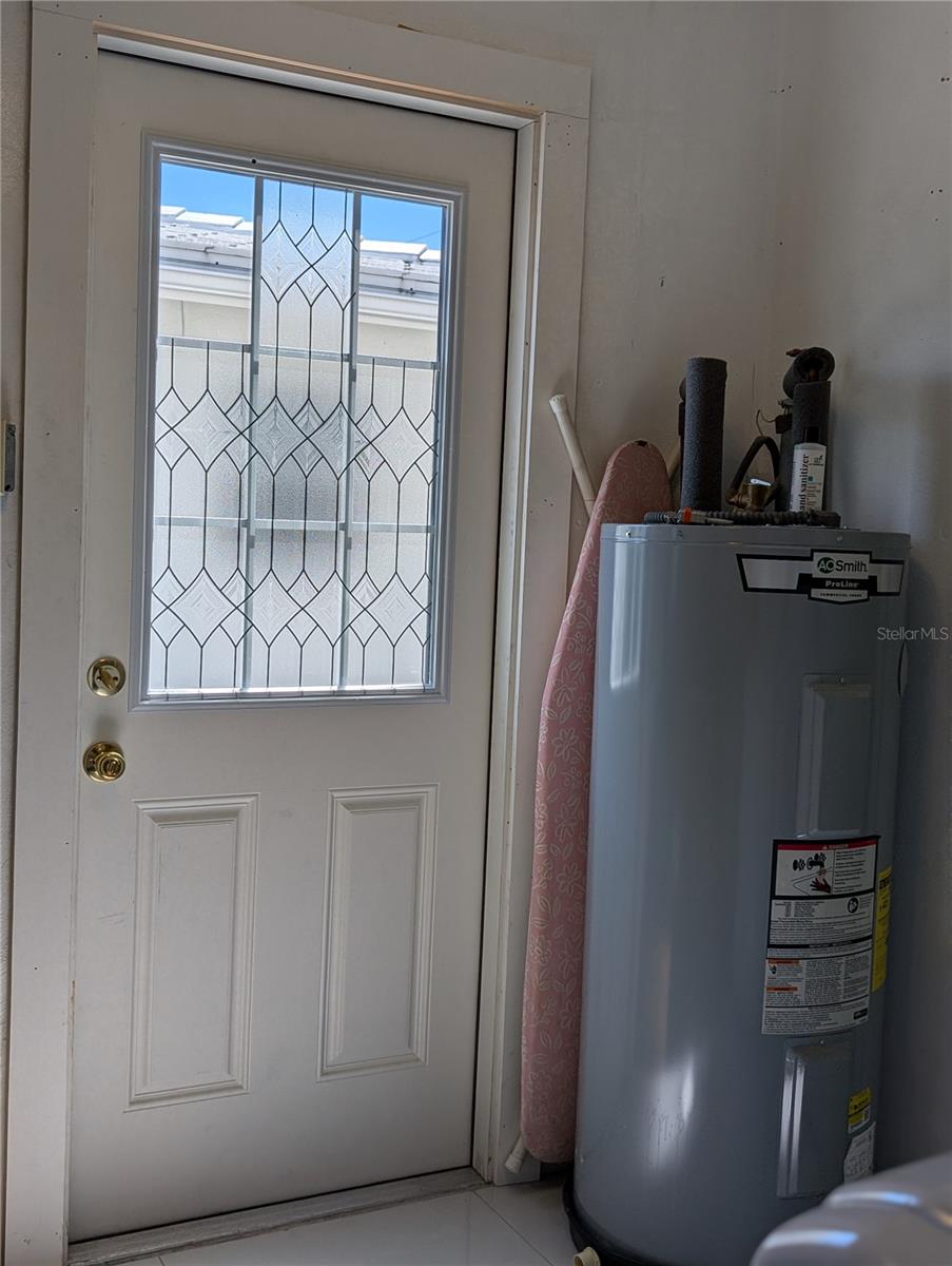 Updated garage man door accesses side yard.  A. O. Smith 40-gallon water heater   approximately 4 years old.