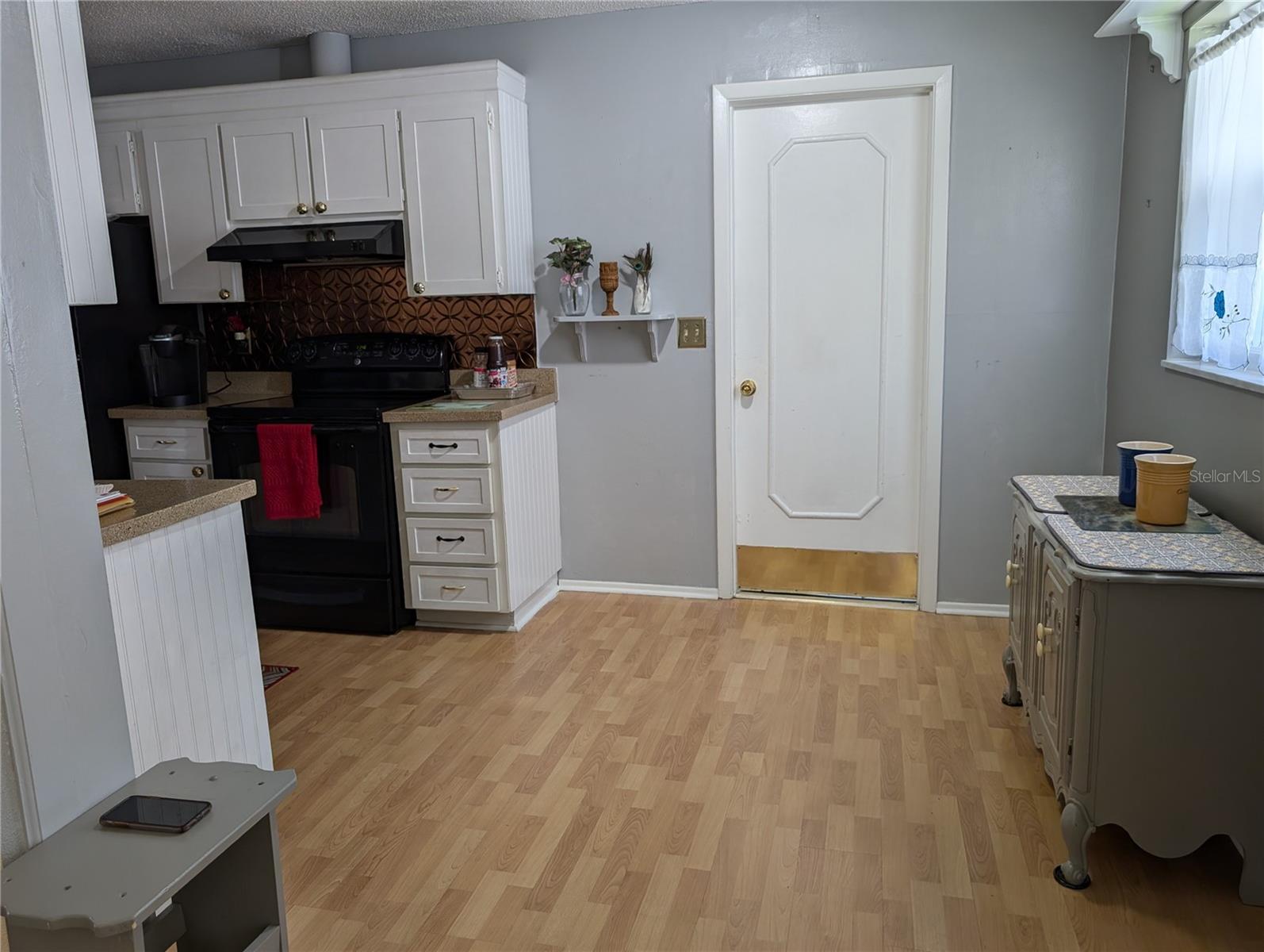 View from Florida room thru eat in kitchen to garage entry.