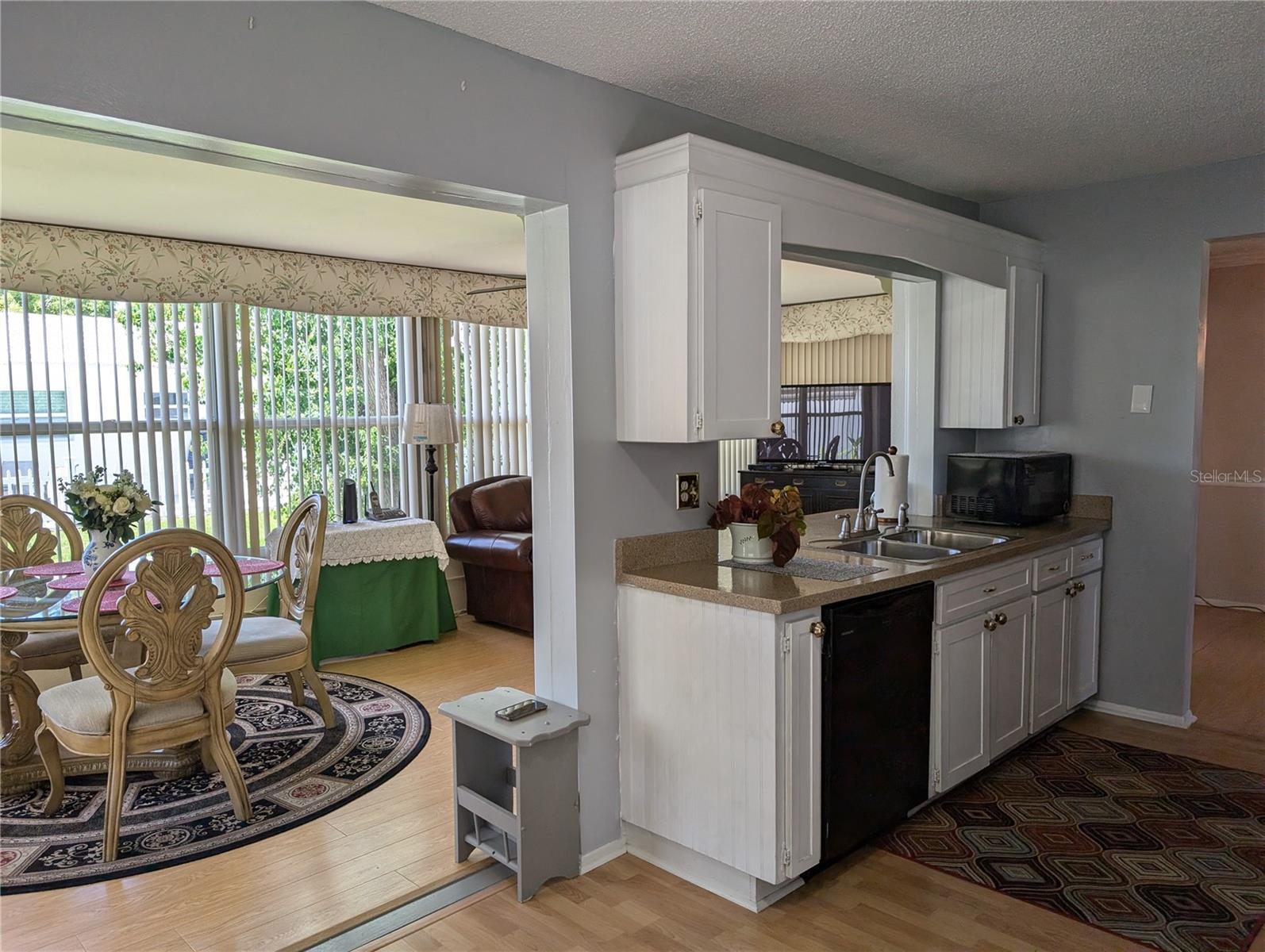 View of kitchen pass thru window into Florida room.