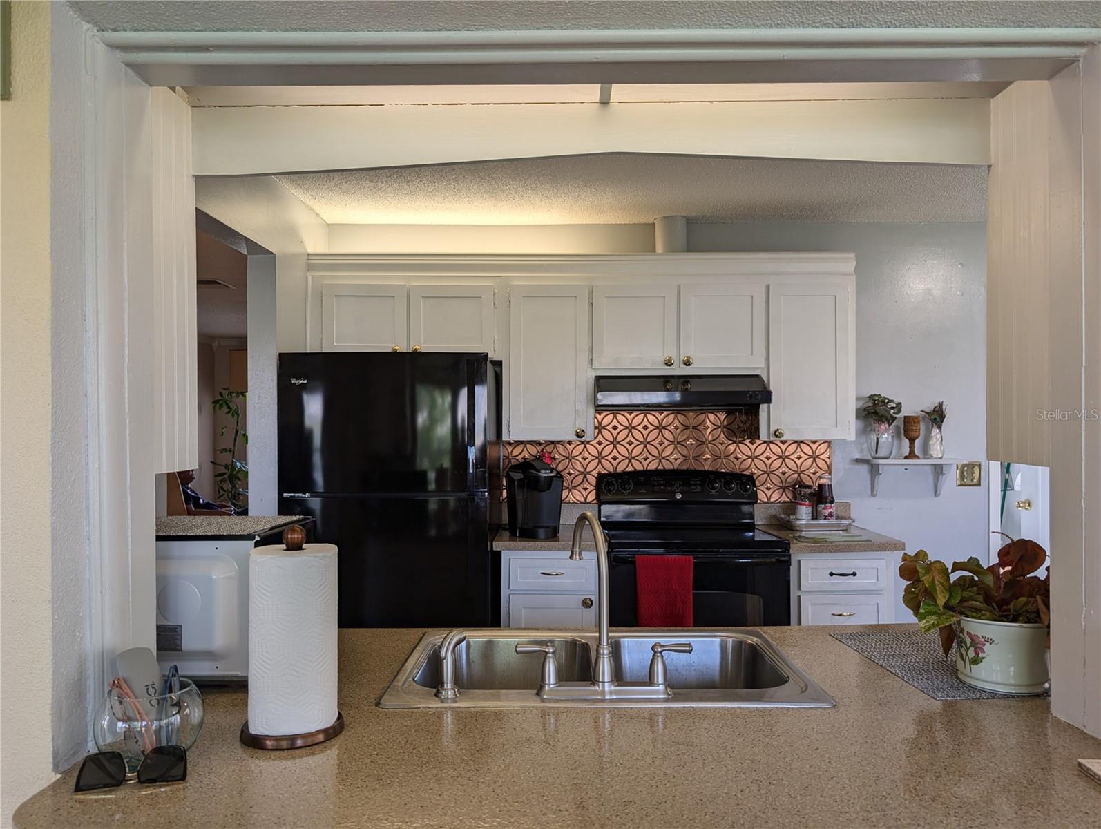 Faux tin backsplash adds a touch of old world charm.