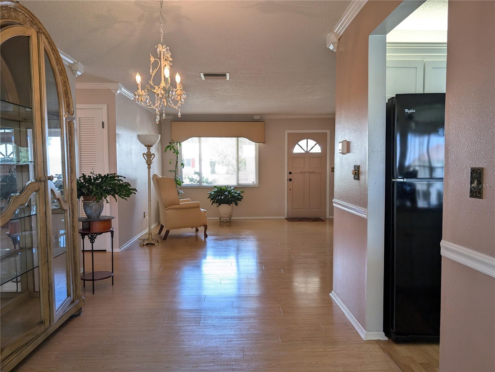 View of dining room thru to living room.  Hall to bedrooms and baths on left.  Kitchen to the right.