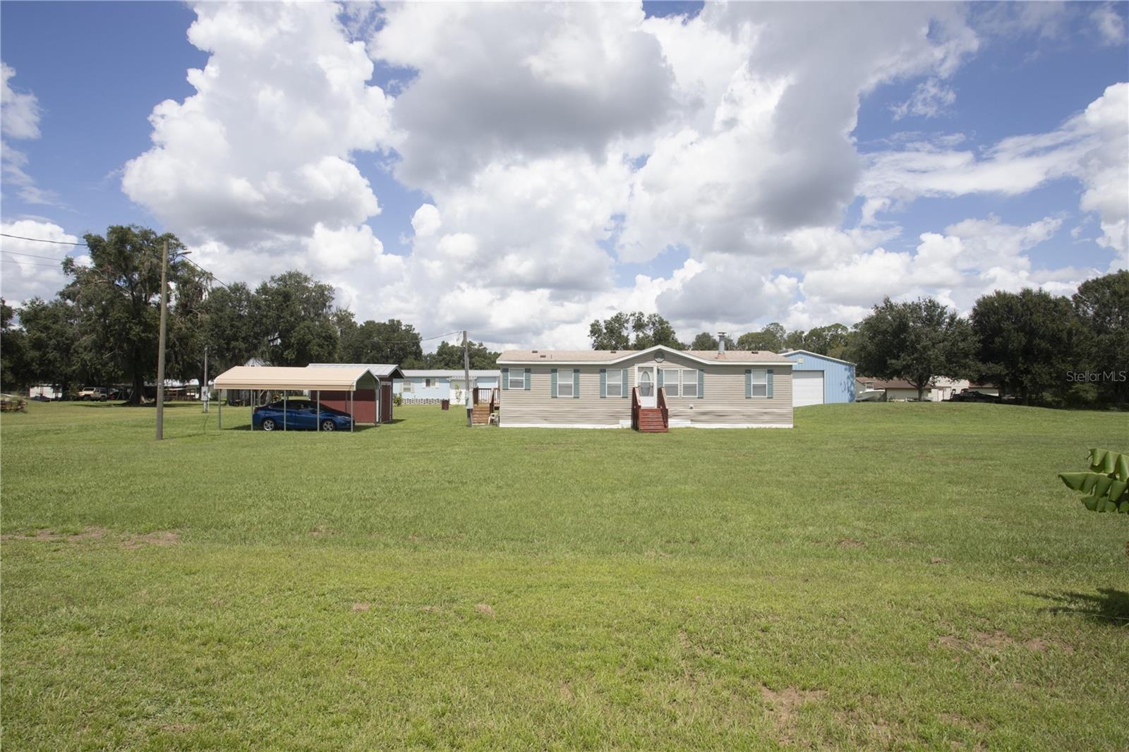 An acre, a shed, a carpot, and a home? What an amazing find!