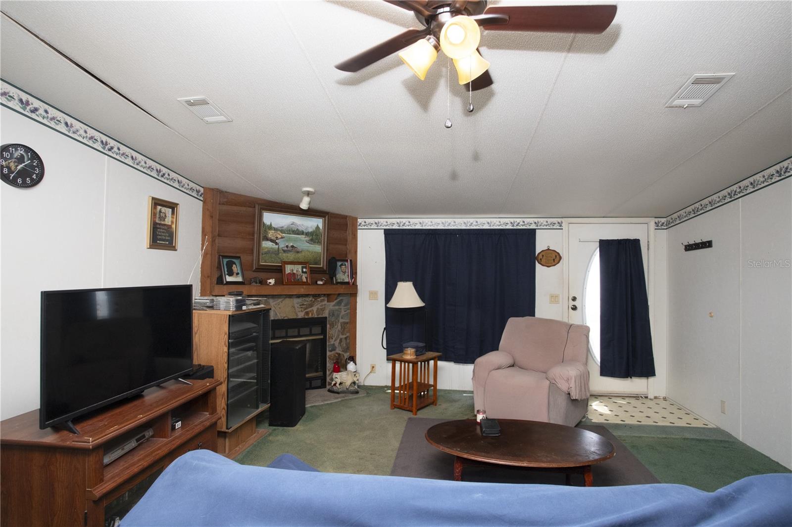 Living room with wood burning fireplace