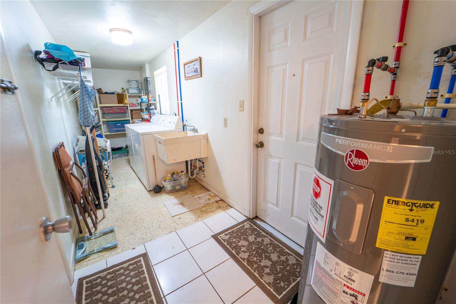 LAUNDRY ROOM WITH ACCESS TO BOTH THE GARAGE AND BACKYARD