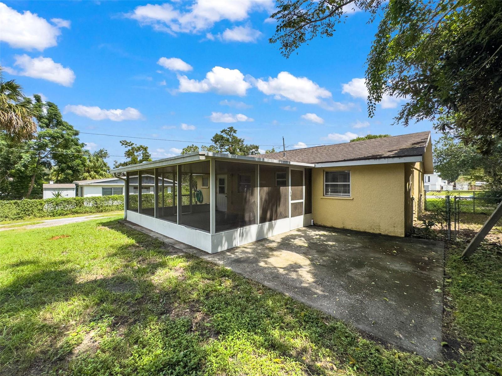 Rear of home with Screened Lanai & Open Patio