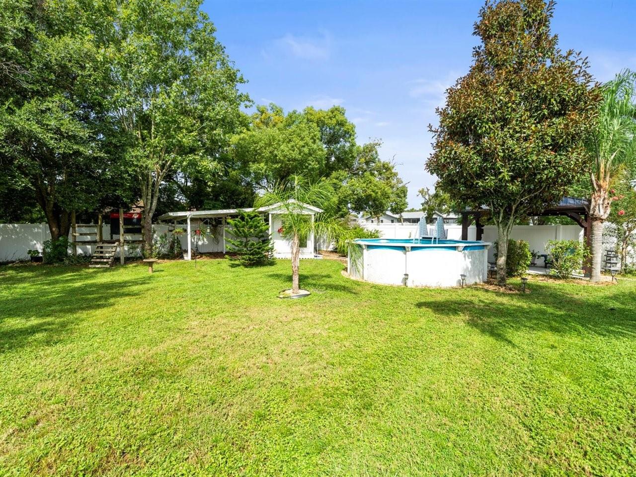 Expansive backyard with playhouse