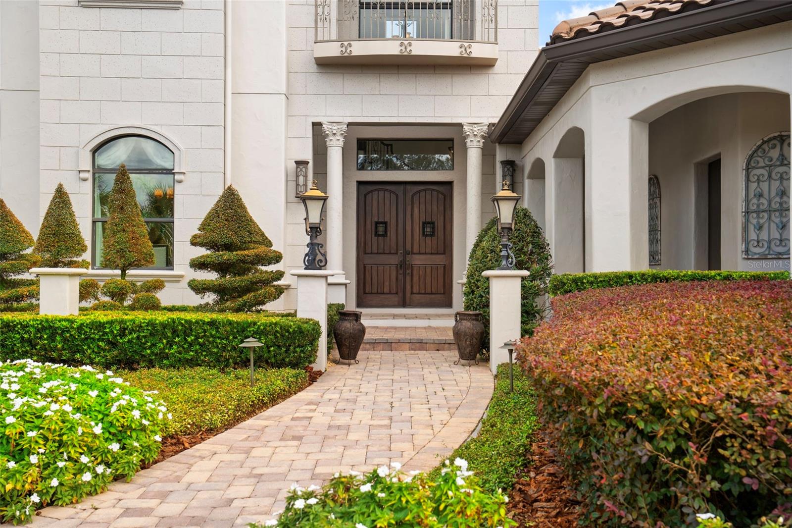 Double door entrance with breezeway and paved walkway.