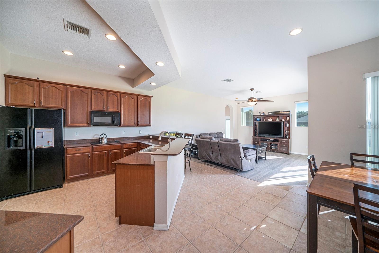 his kitchen is perfect for entertaining and family time! Lots of counter space and plenty of cabinets for all your cookware! CUSTOM WOOD CABINETRY, GRANITE countertops.