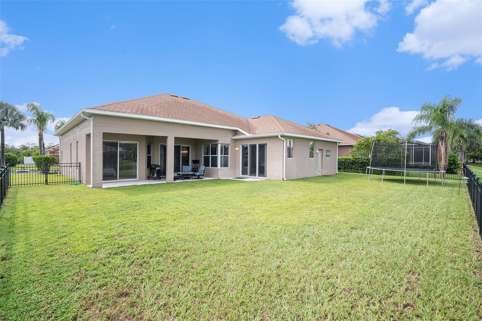 Perfectly fenced backyard for family fun, furry friends, and entertaining guests.