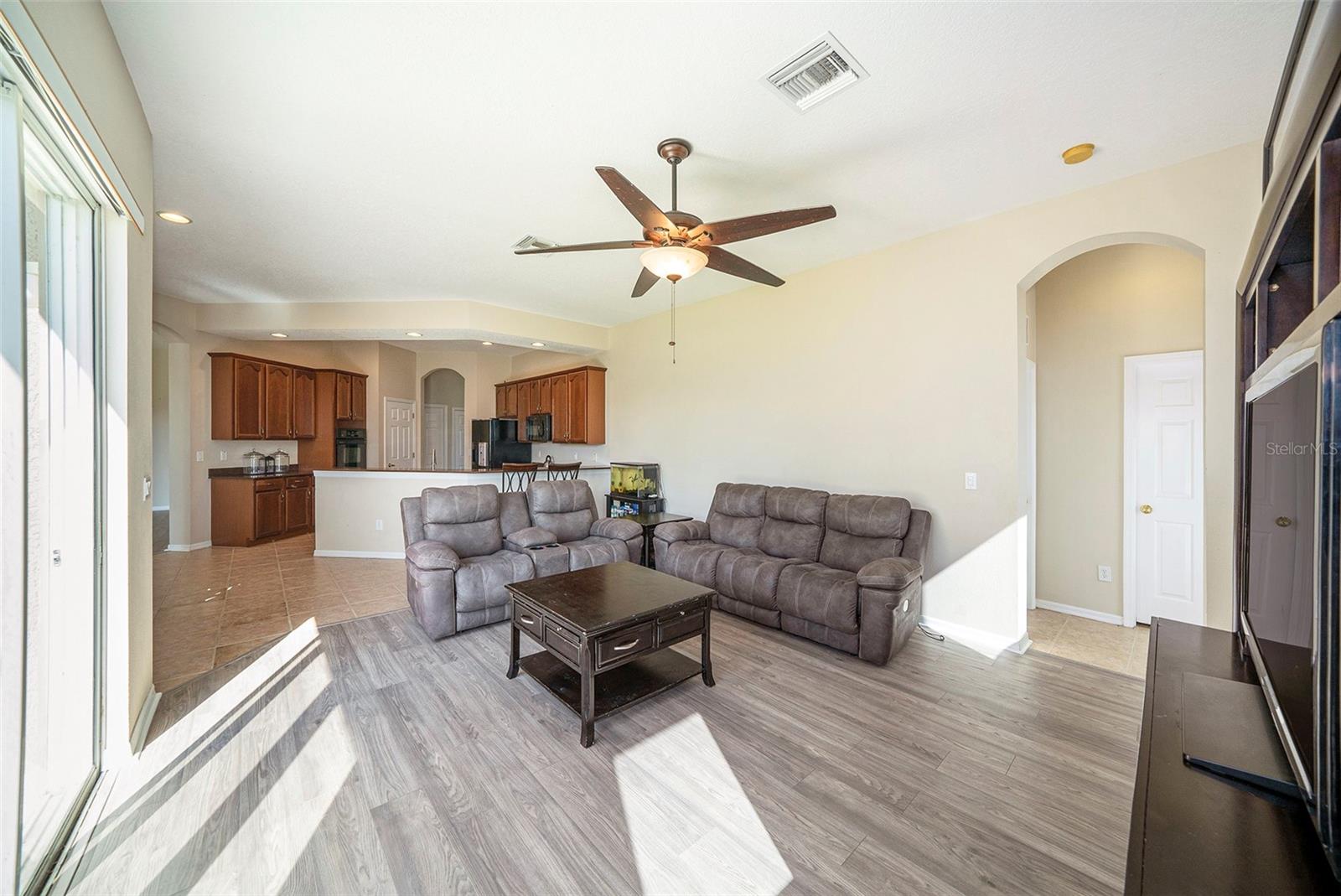 NEW FLOORING IN THE LIVING ROOM AND FAMILY ROOM.