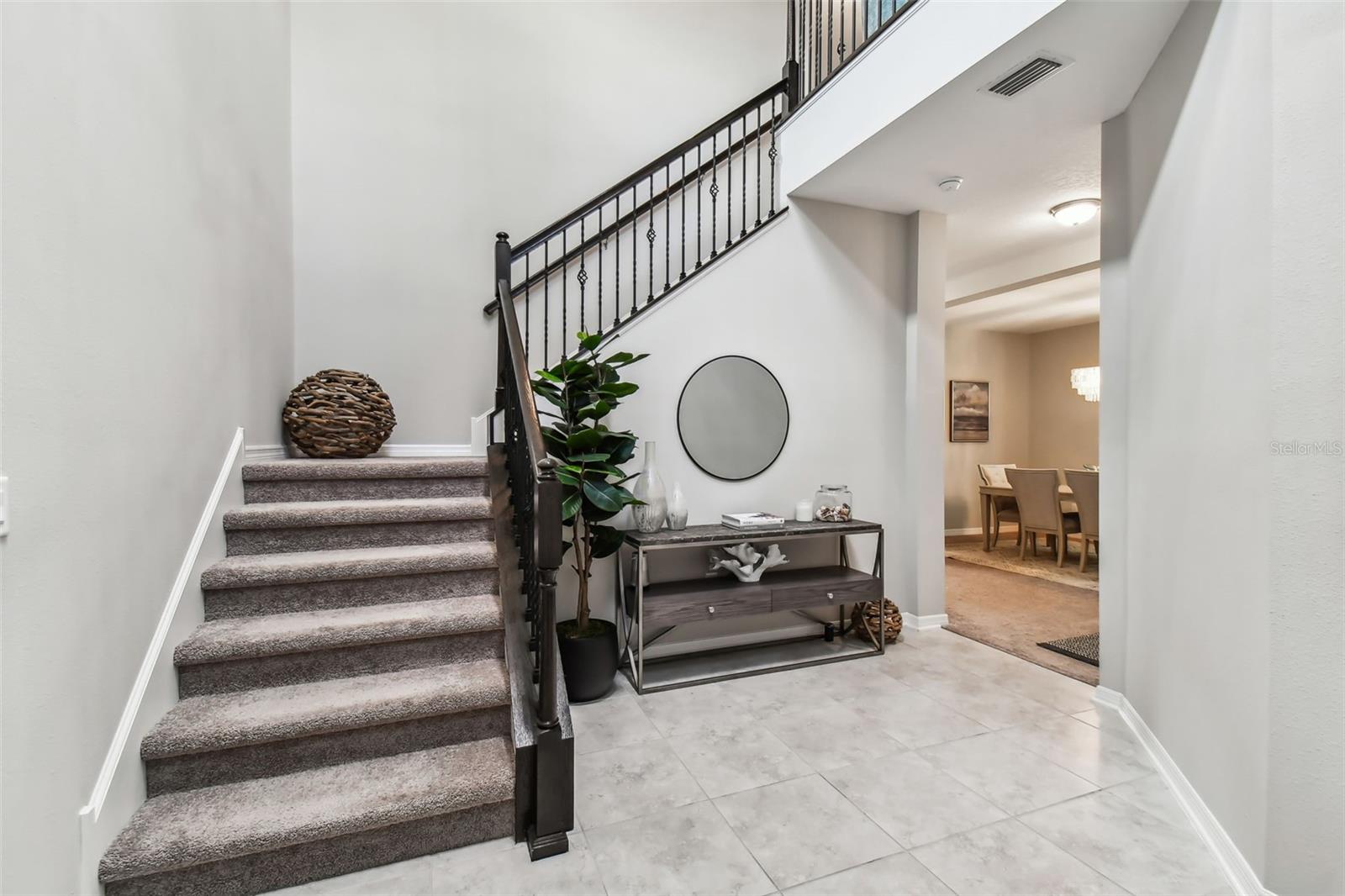 Stately foyer with soaring ceiling and gorgeous chandelier