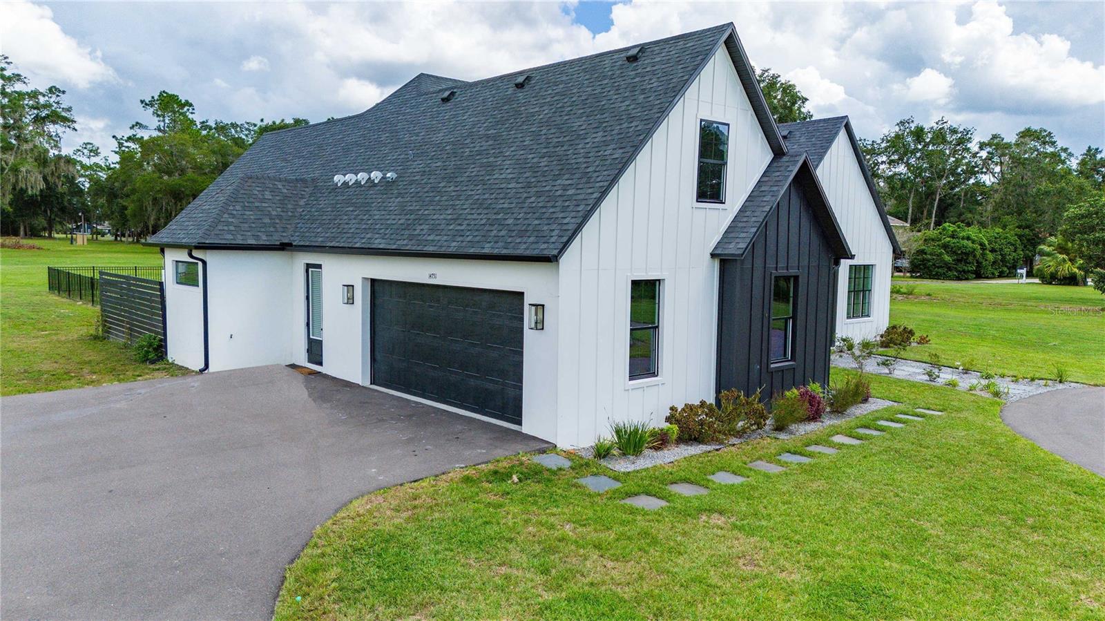 North Exterior View | 2 Car Garage and Parking Pad