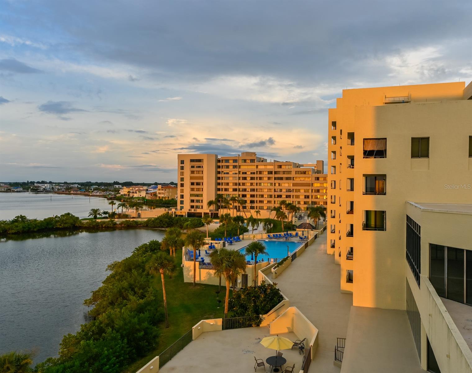 View of pool at sunset from balcony