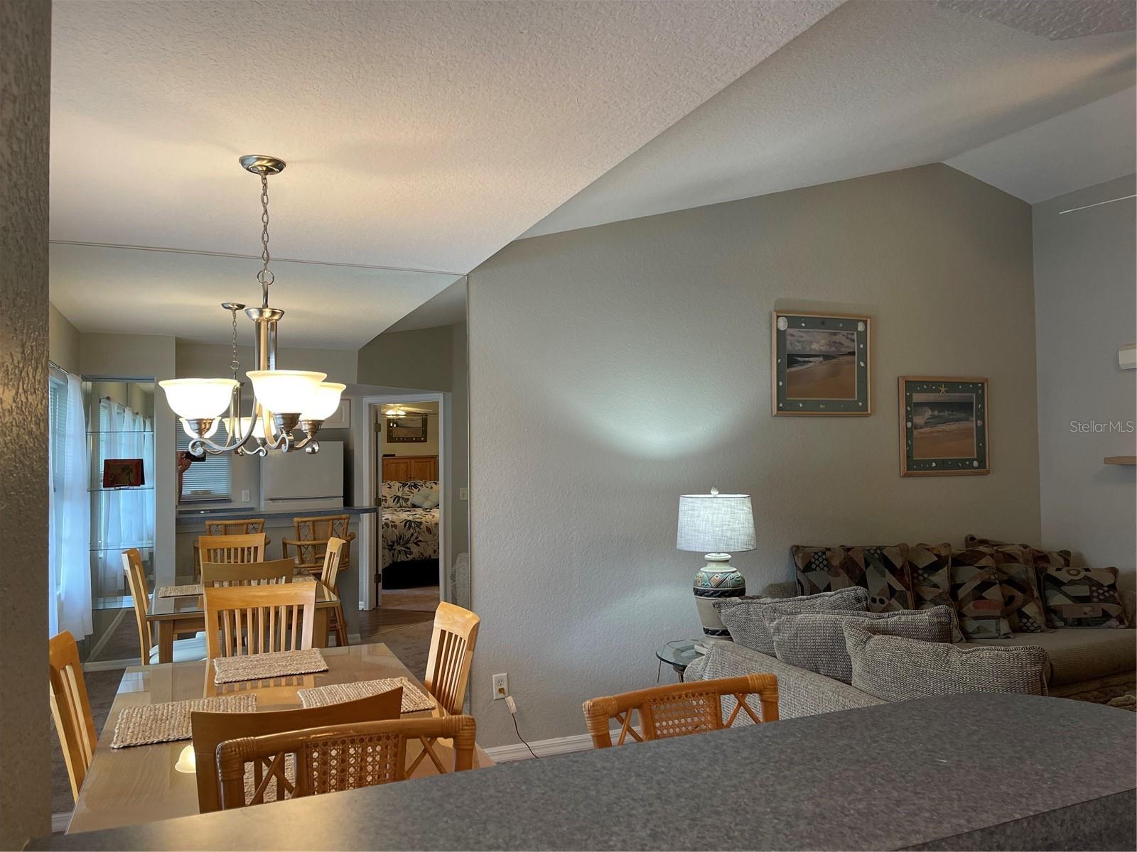 Mirrored accent wall in dining room adds extra light