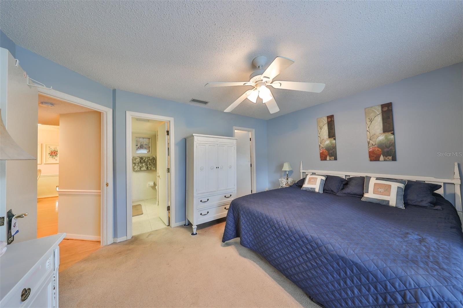 The master bedroom is large with space for a king size bed and multiple pieces of furniture.  Notice the en-suite bathroom.