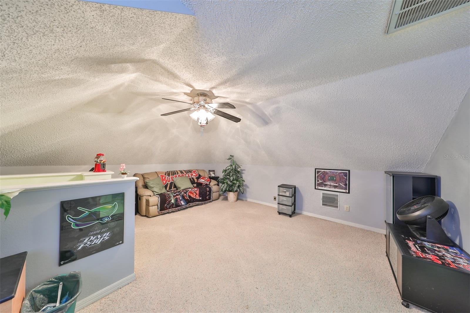 High ceiling, private bathroom and large window make this a perfect teenager's space or guest room.