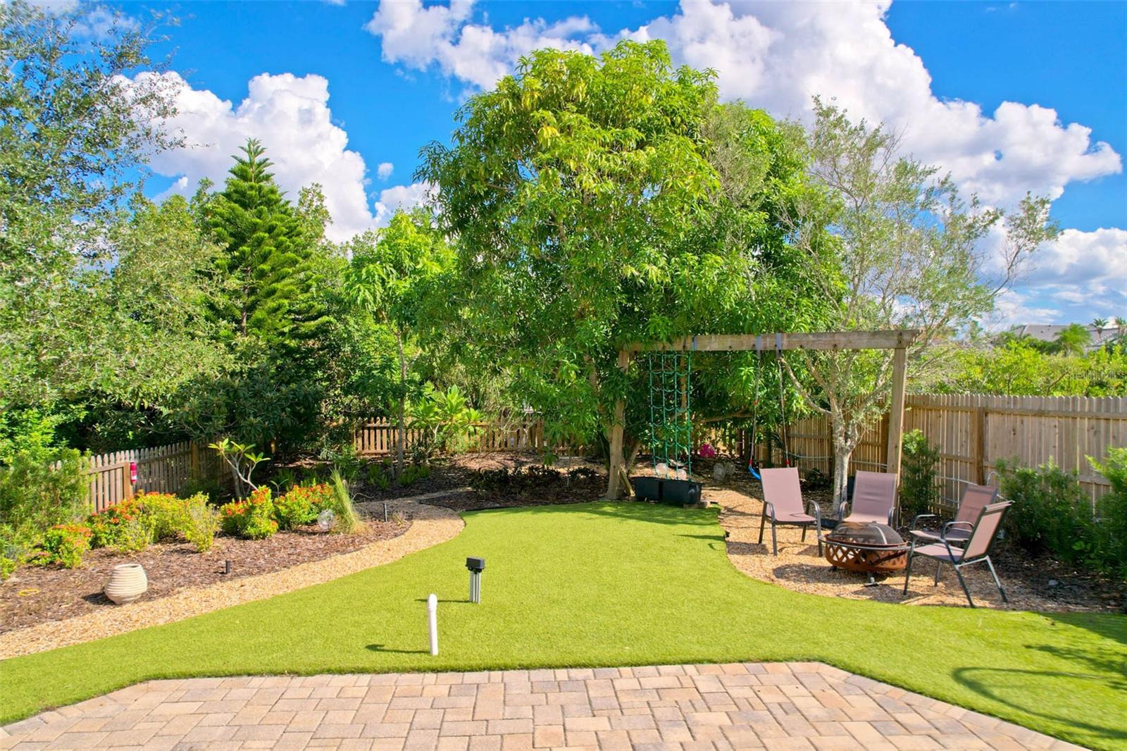 Lush greenery and tropical landscaping lead you out to the canal and your private composite dock.