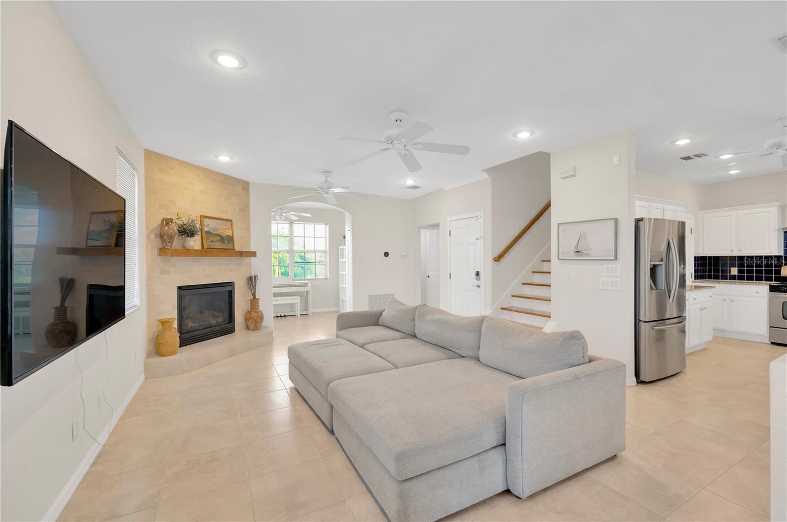 The living room offers a gas fireplace & alcove off the living room overlooks the backyard and canal.