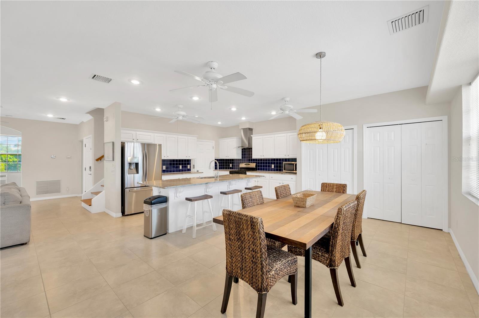 The huge island includes a breakfast bar with extra seating for large gatherings with connection to the dining area.