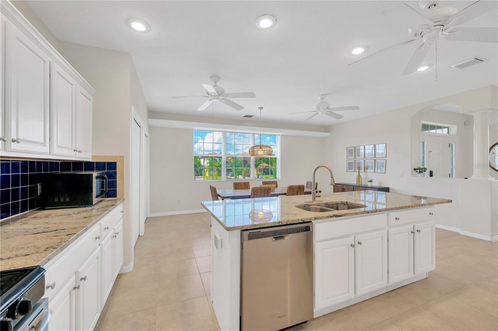 Kitchen is seamlessly connected to Dining room and Living room with partial views of Tampa Bay.
