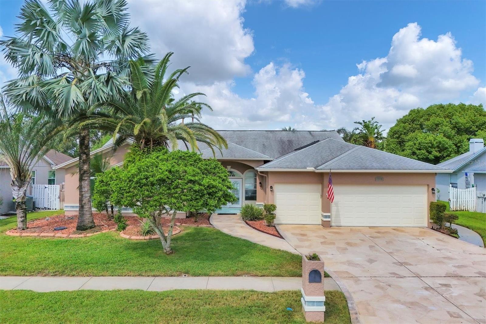 Mature landscaping and freshly trimmed palms.