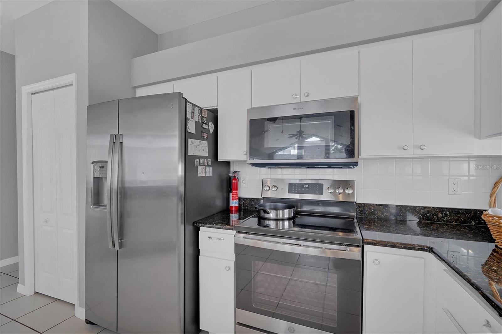 Plant shelf above cabinets hold decor if desired.