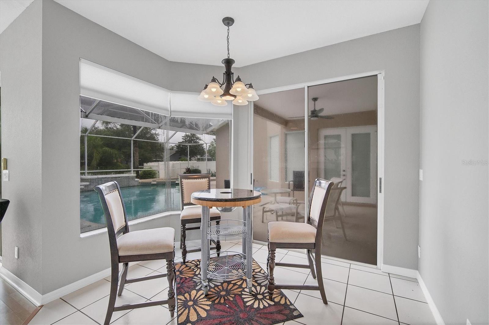 Dinette features aquarium glass window and sliding doors to the patio.