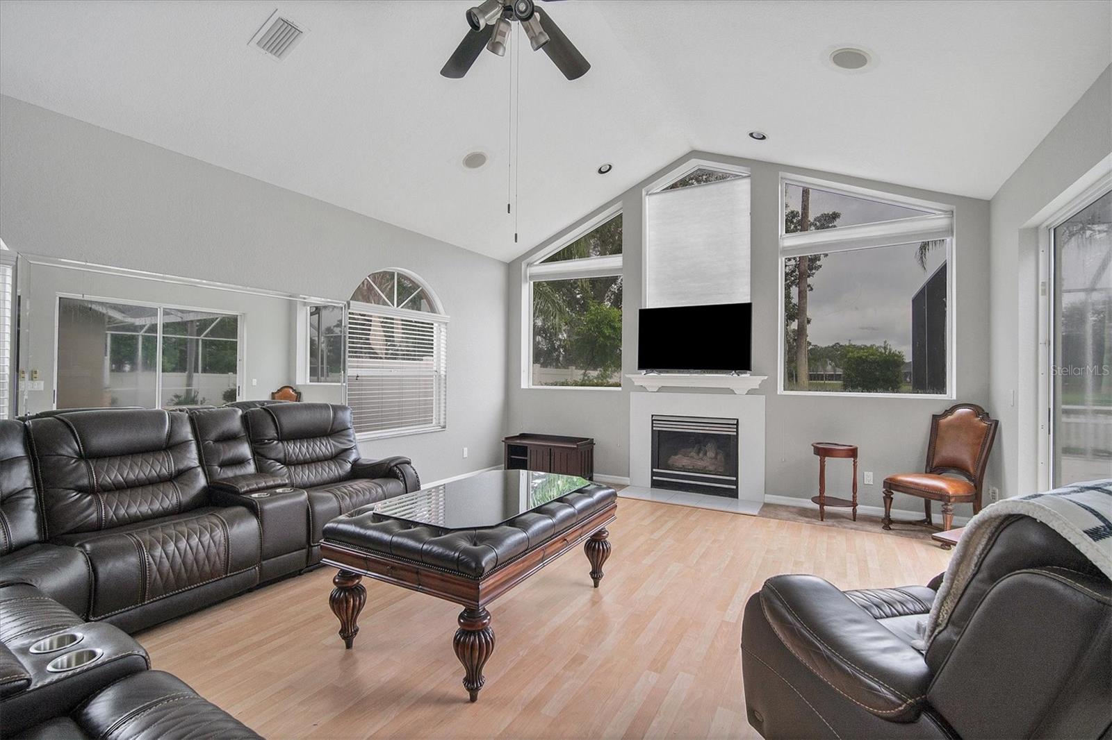 Family Room has gas fireplace, large windows and a mirrored wall (behind couch) to reflect the natural light.