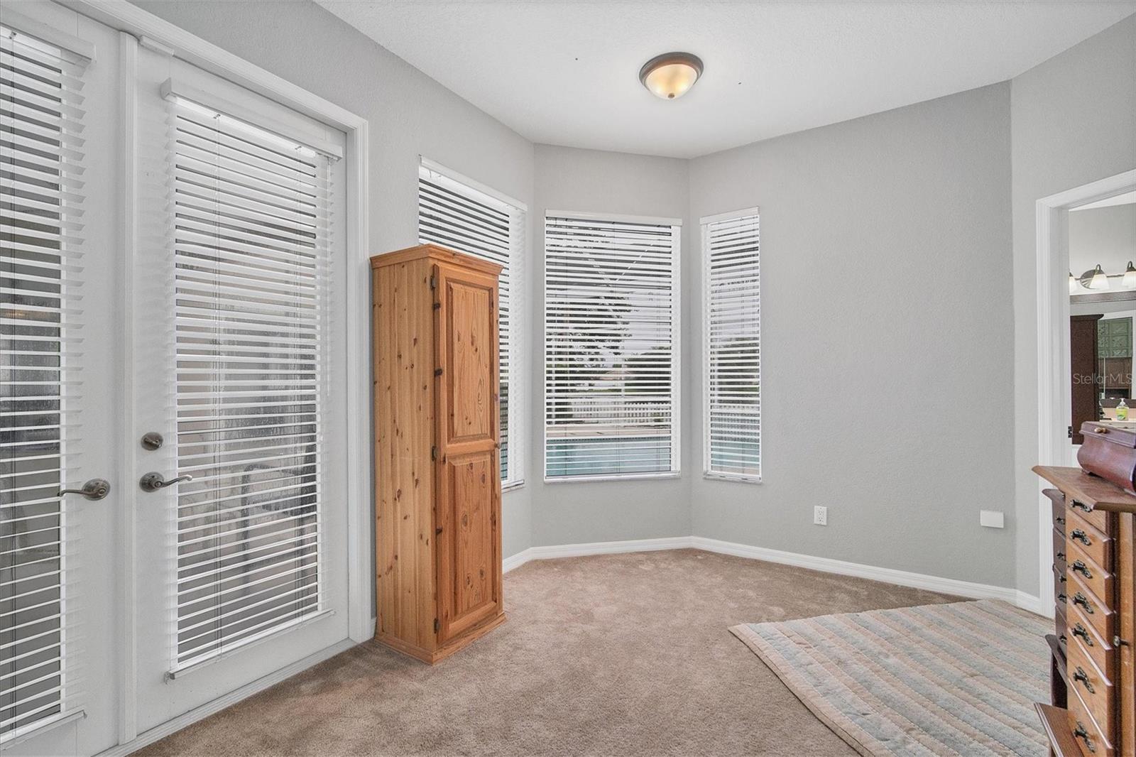 French doors lead to pool/patio