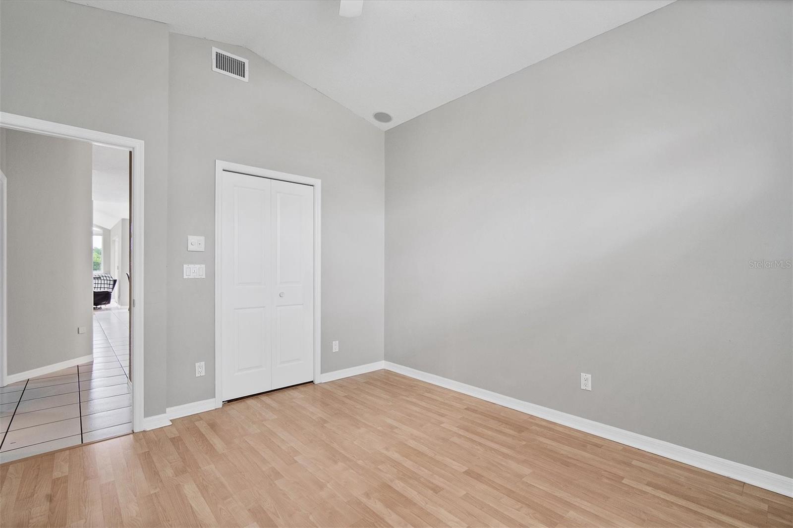 4th bedroom offers a walk in closet.  View down hallway to kitchen/family room