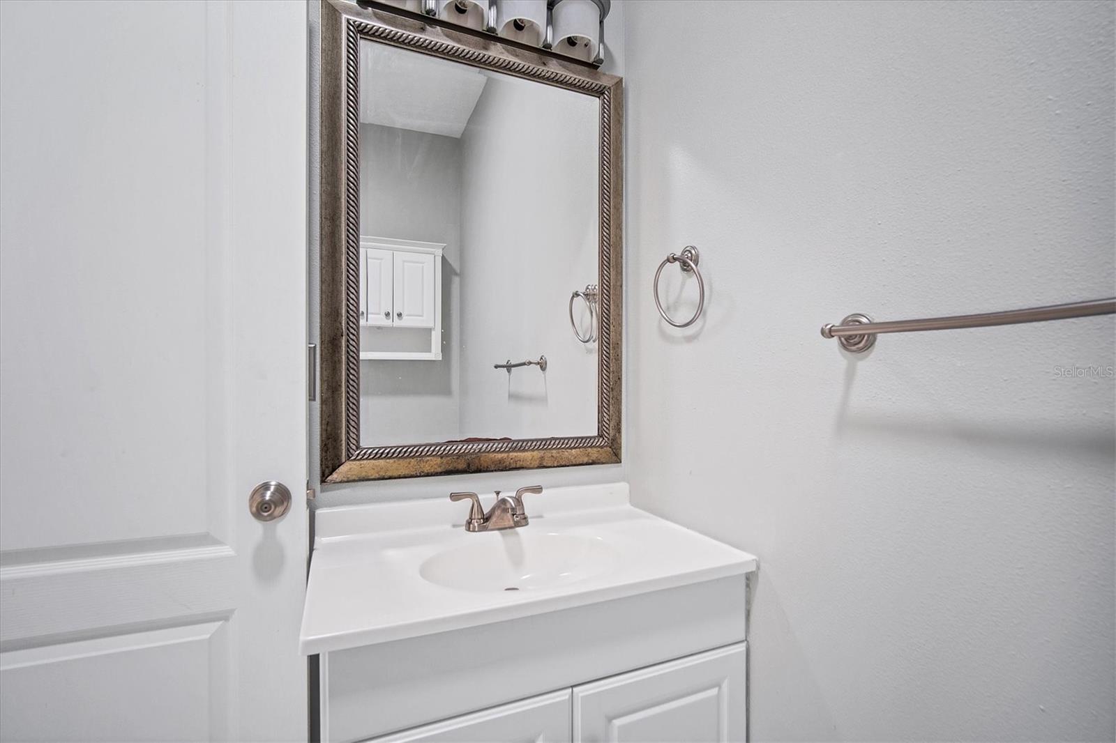 Hall bathroom behind kitchen on way to front bedrooms