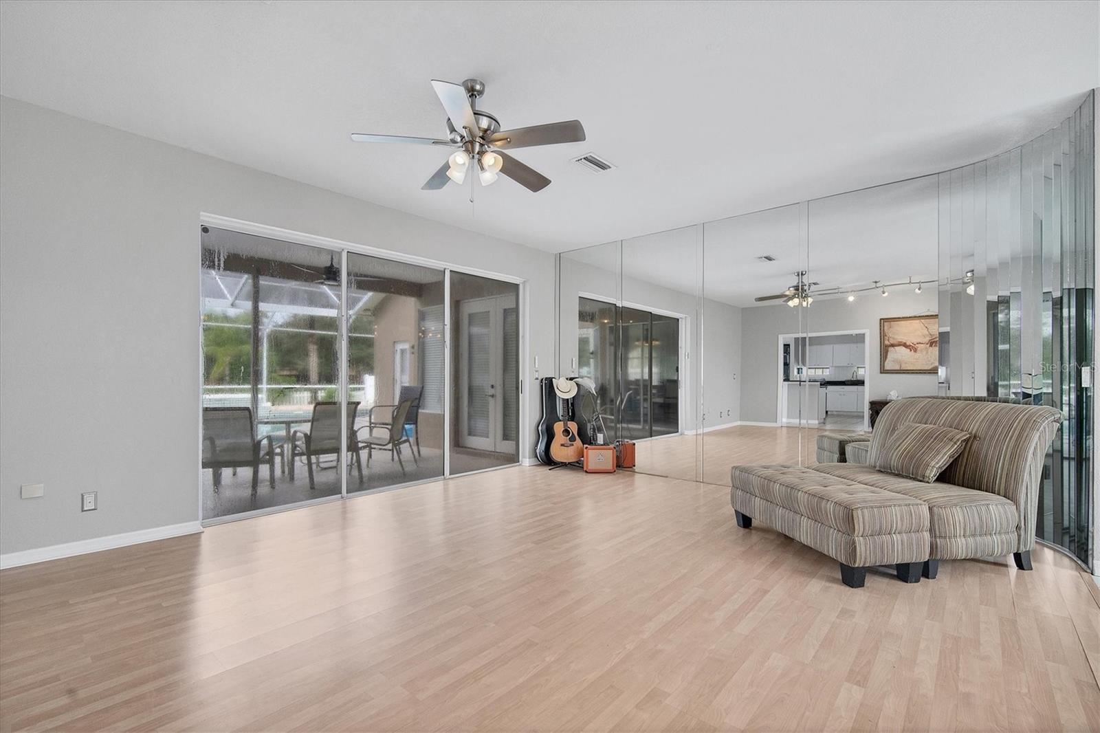 Front living space as you enter home.  Open & bright with triple sliding doors to the pool/patio.