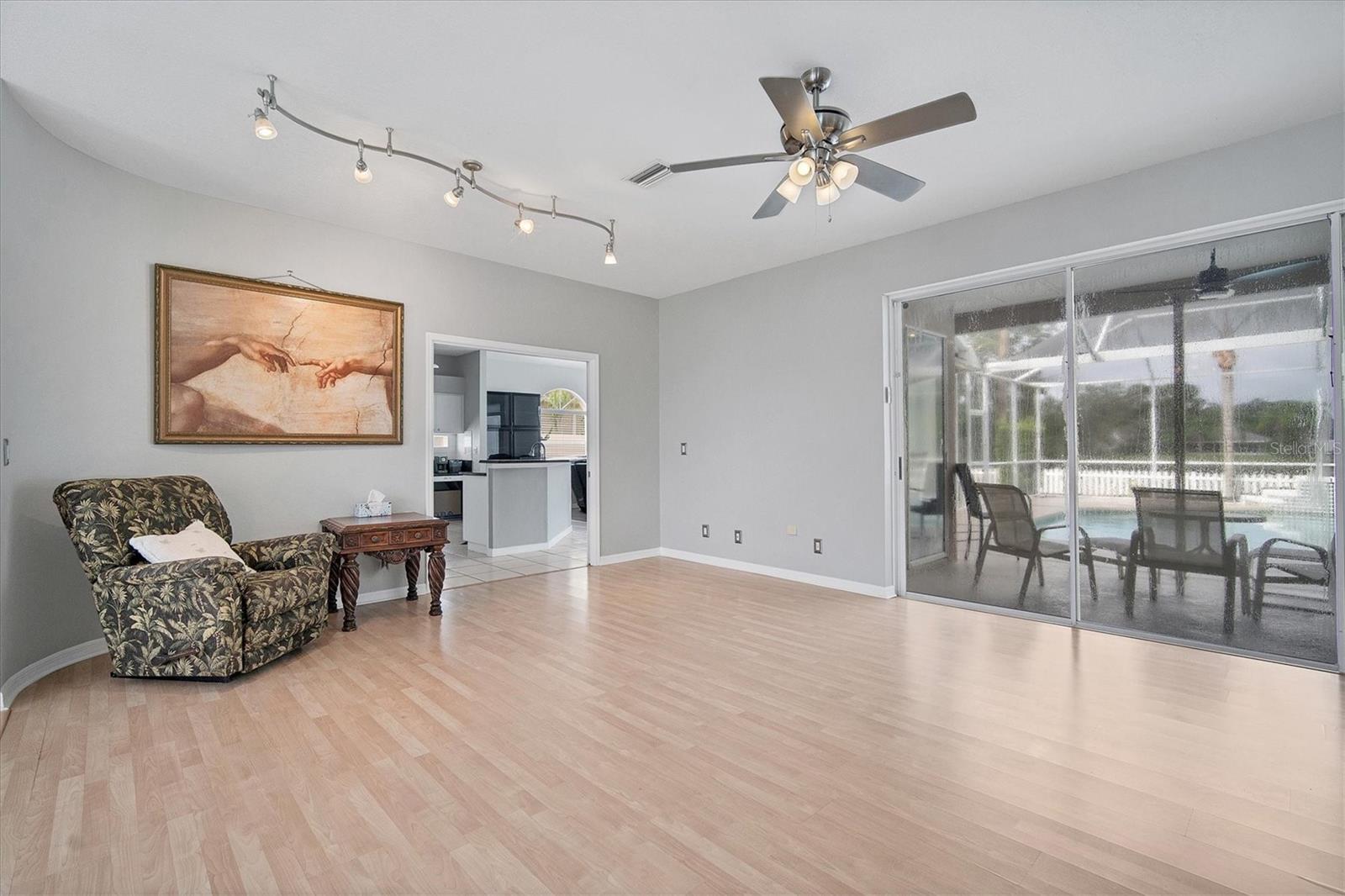 View into kitchen/family room and outside to patio/pool