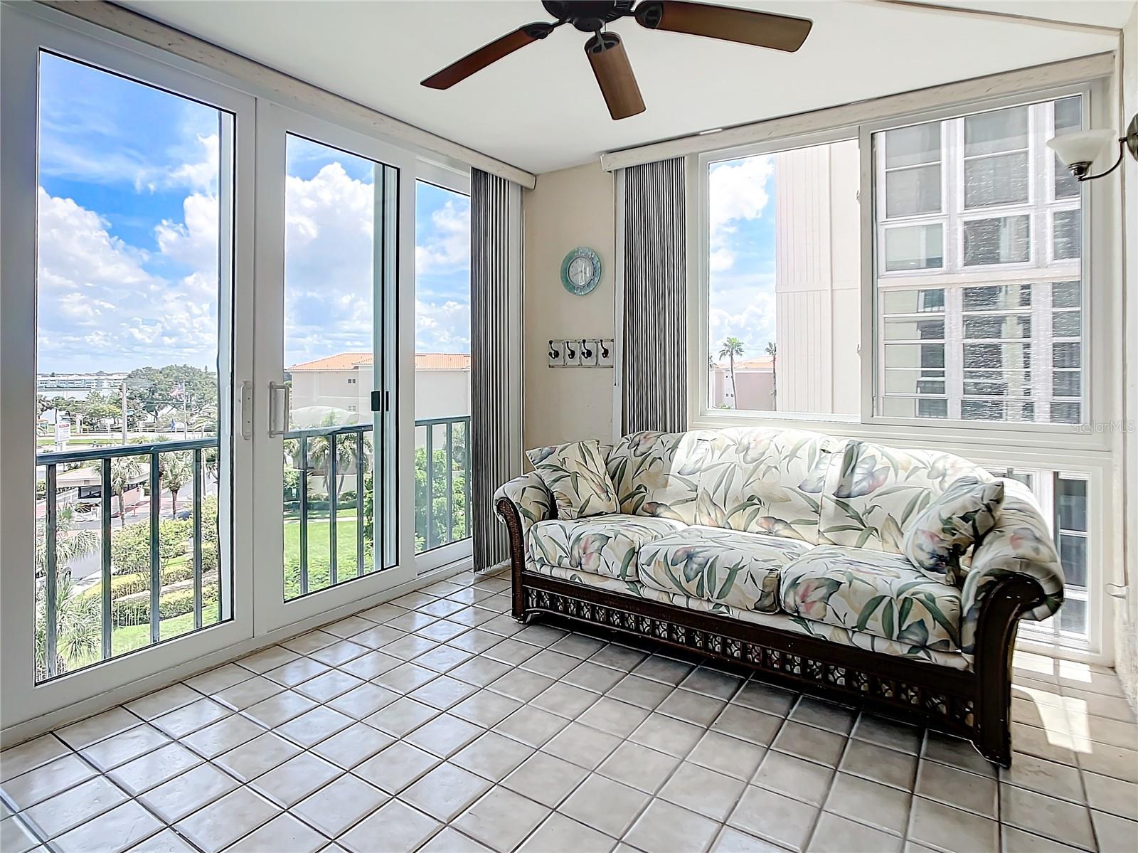 Another view of the enclosed patio that has a couch that opens to a bed for guests.