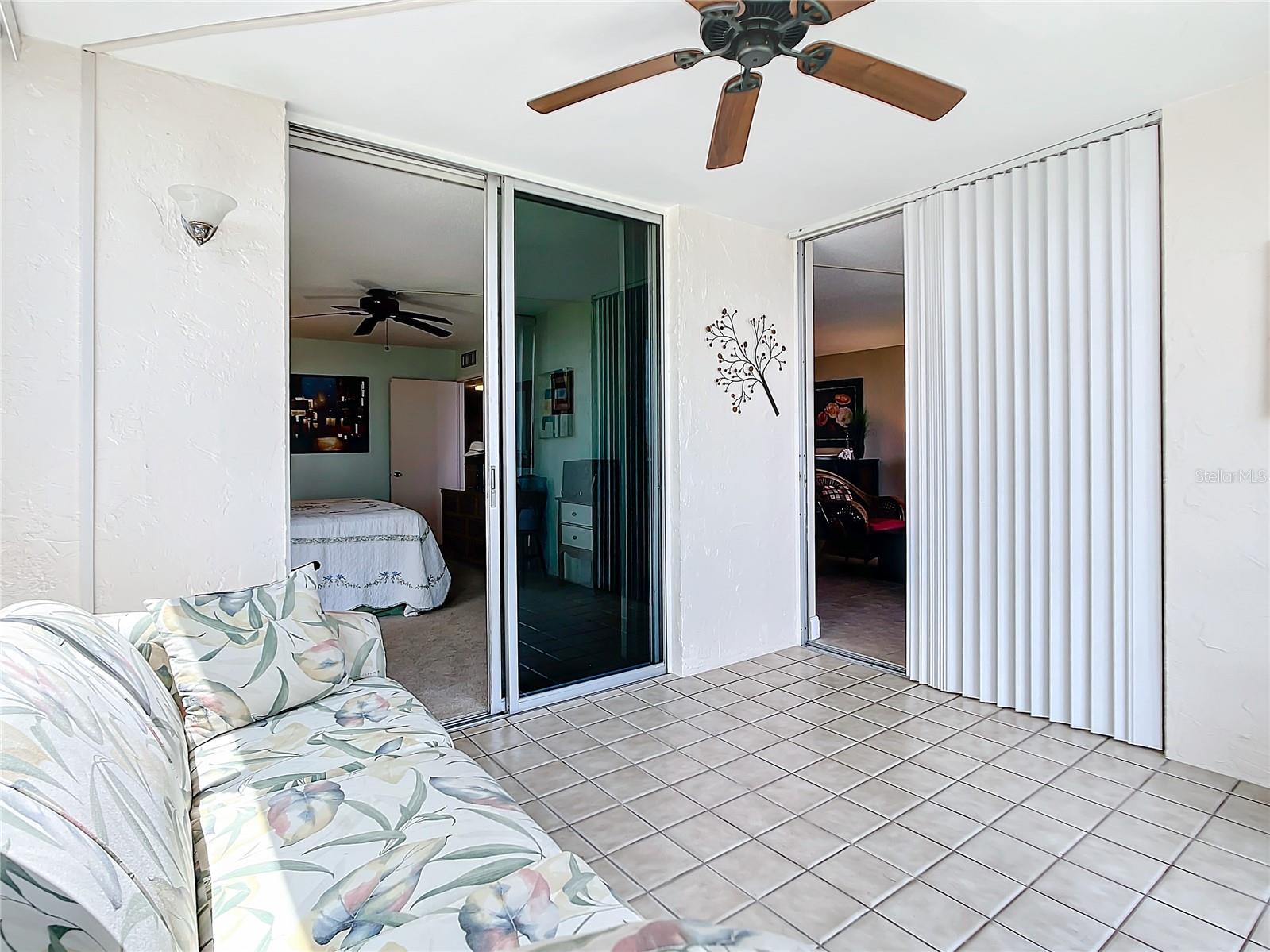 The enclosed porch has sliders from the living area and from the primary bedroom