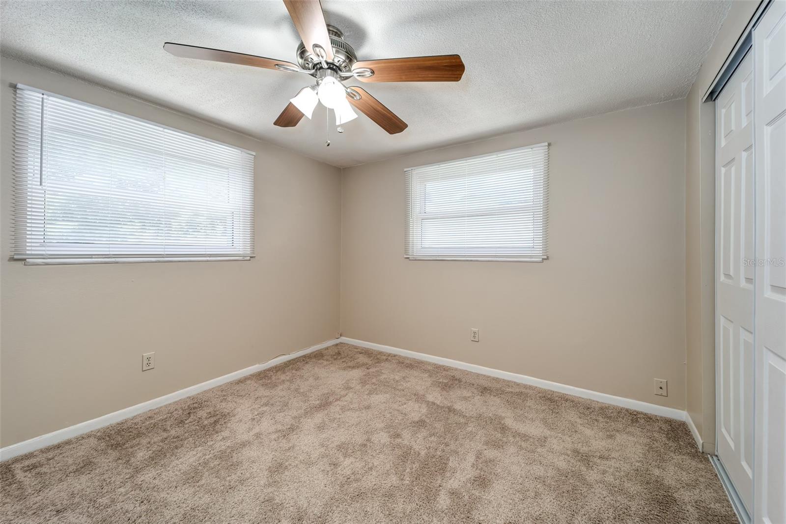 Second bedroom light and bright with window view to lovely and private rear yard