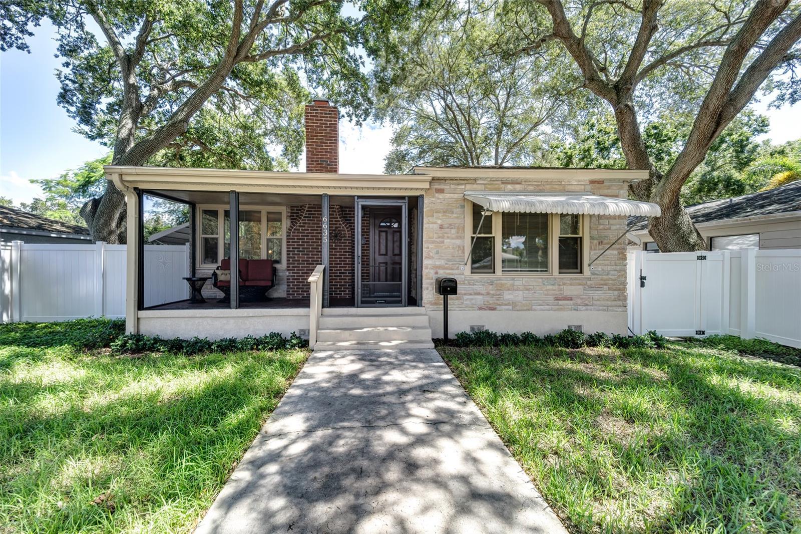 Front closer view of home with inviting screened front porch...awnings easily slide off if you want to remove them